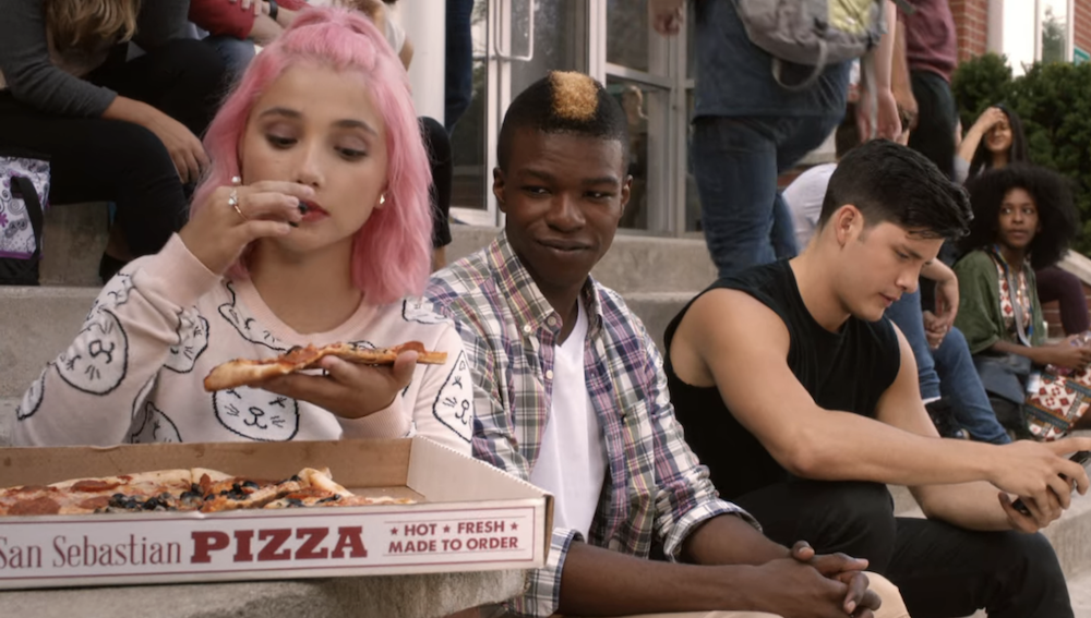 a character eating a pizza outside with others around