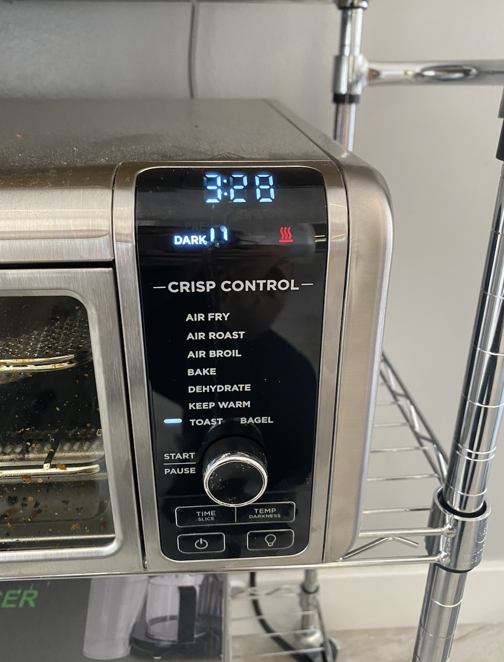 Air fryer panel with &quot;toast bagel&quot; selected for crisp control and &quot;dark,&quot; and 3:28 left for the time