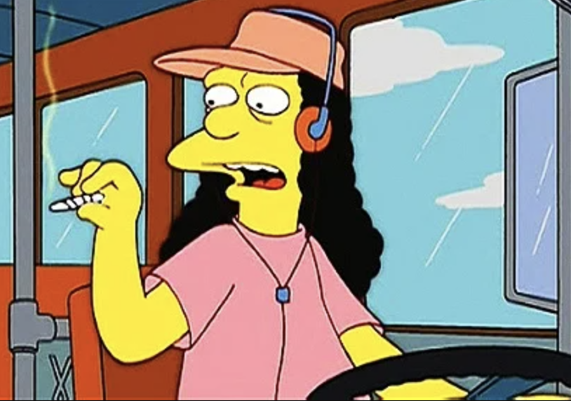 Otto sits in the drivers&#x27; seat of a bus, holding a cigarette, headphones on his ears