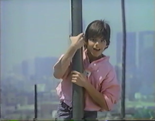 A teenage Ricky holding on to a pole