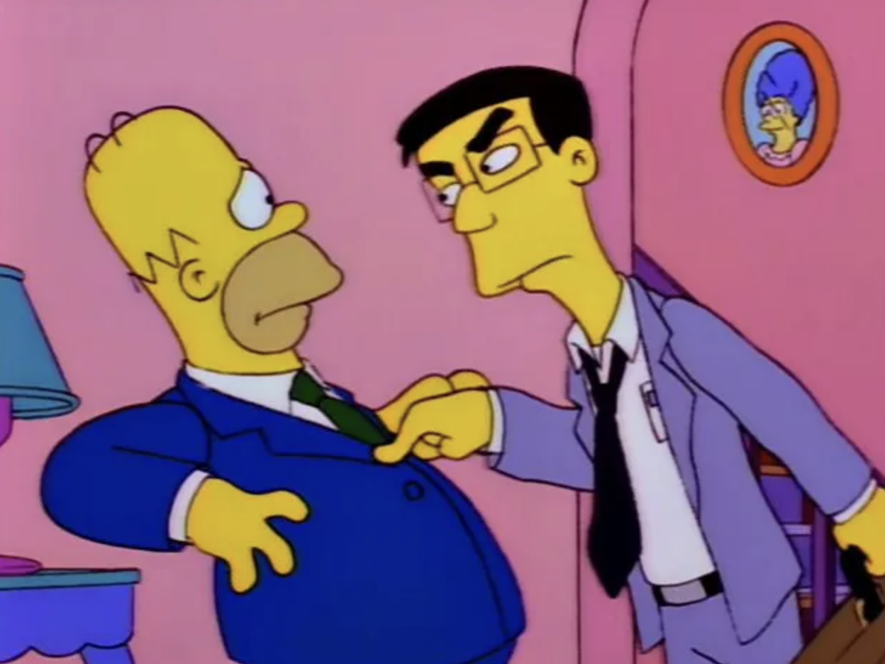 Frank Grimes stands in front of Homer, jabbing him in the chest with one finger and looking angry