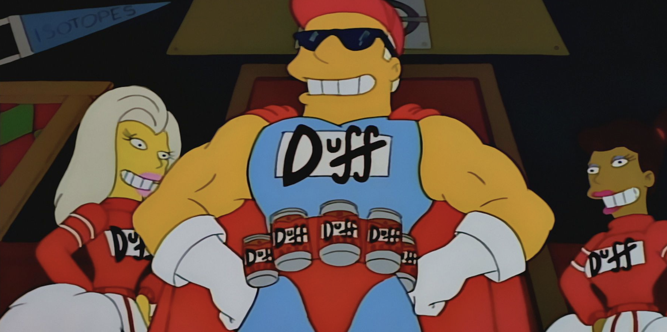 Duffman, a giant muscly man in a superhero outfit, stands with his hands on his hips - he has a belt with beer cans strapped to it