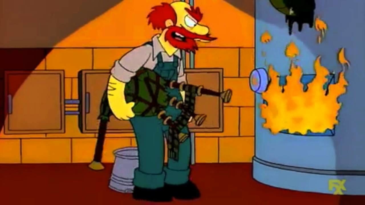 Groundskeeper Willie holds a bagpipe and stands in front of a flaming incinerator