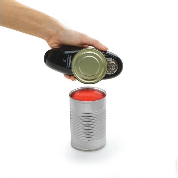 a model holding up the lid from a can and the automatic can opener