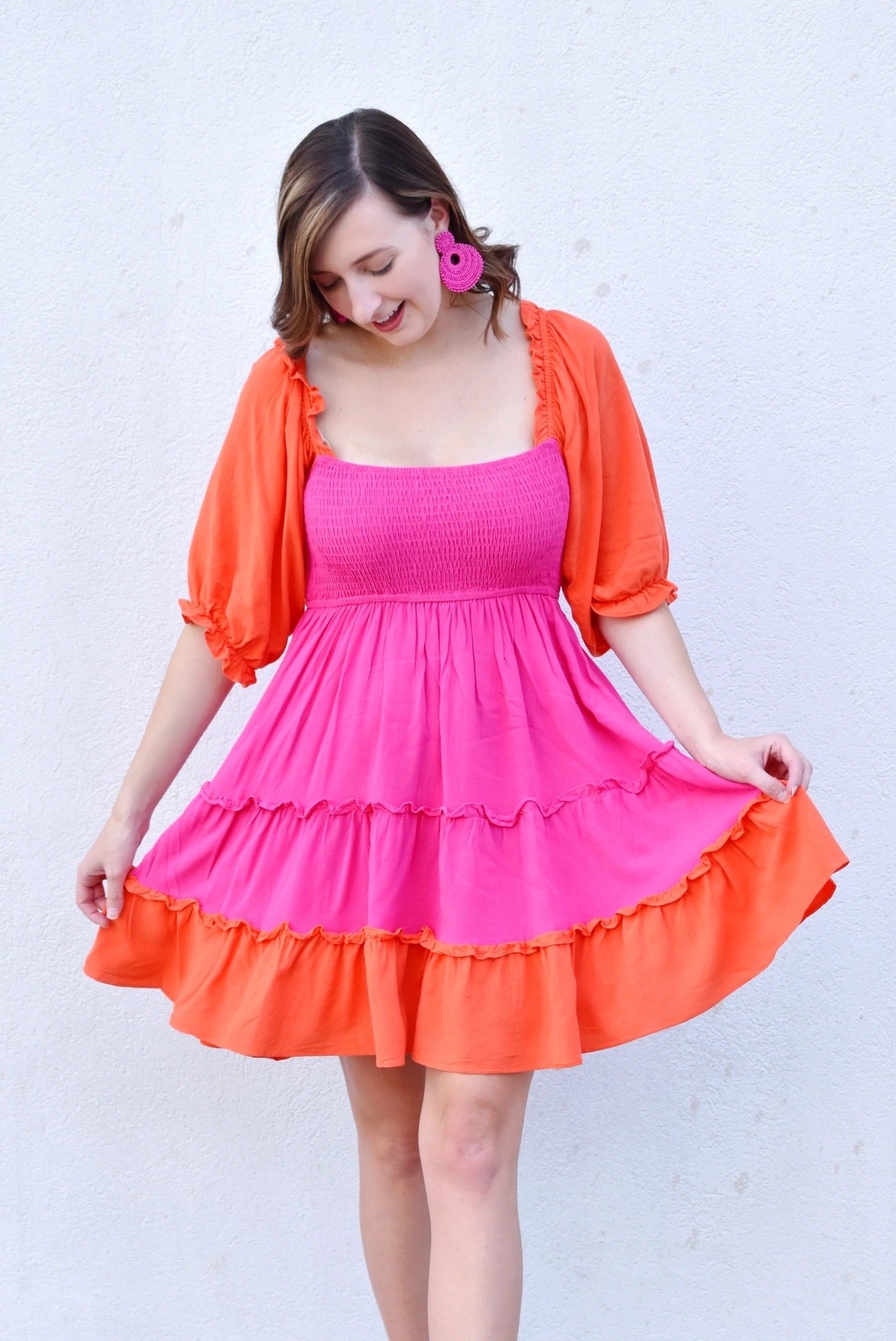 a model wearing the orange and pink dress