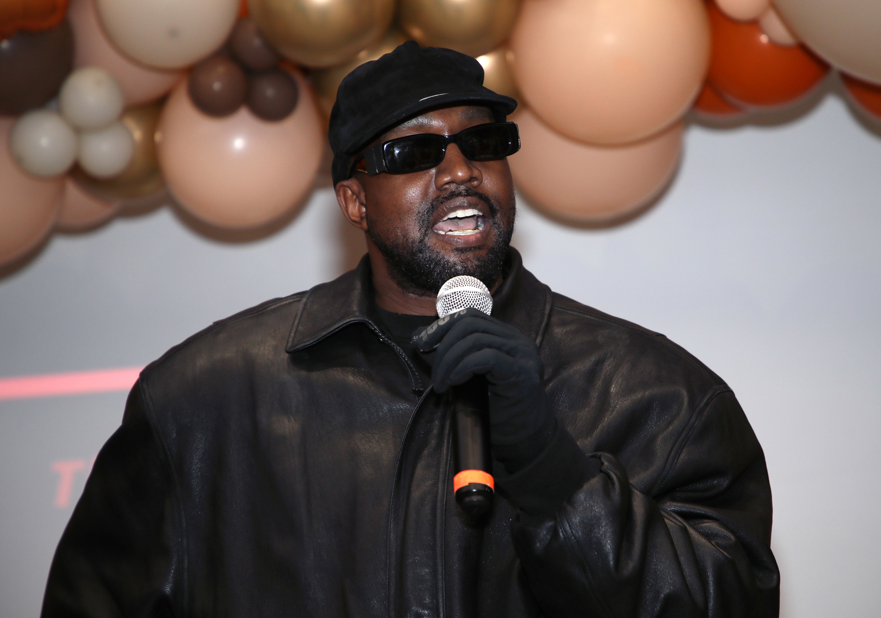 Kanye holding a microphone