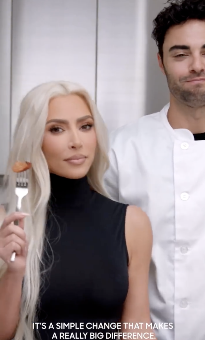 Kim holds up a fork with a piece of a Beyond Meat product in a promotional video, with the caption reading, &quot;It&#x27;s a simple change that makes a really big difference&quot;