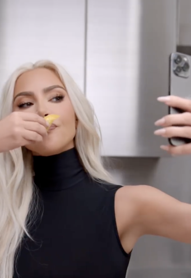 In the promotional video, Kim holds up a tortilla to her mouth and pretends to take a selfie with her phone