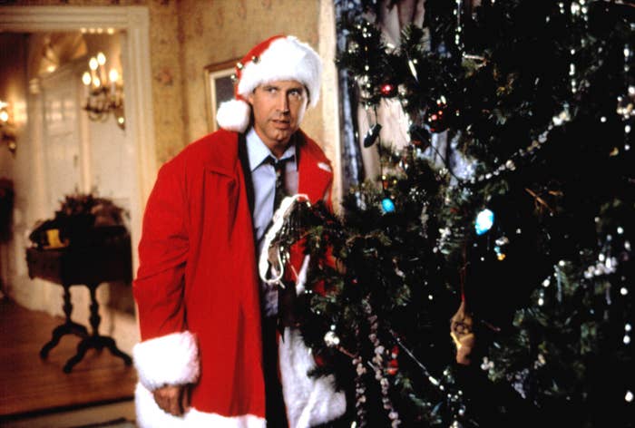 Chevy Chase hiding behind an elaborate Christmas tree