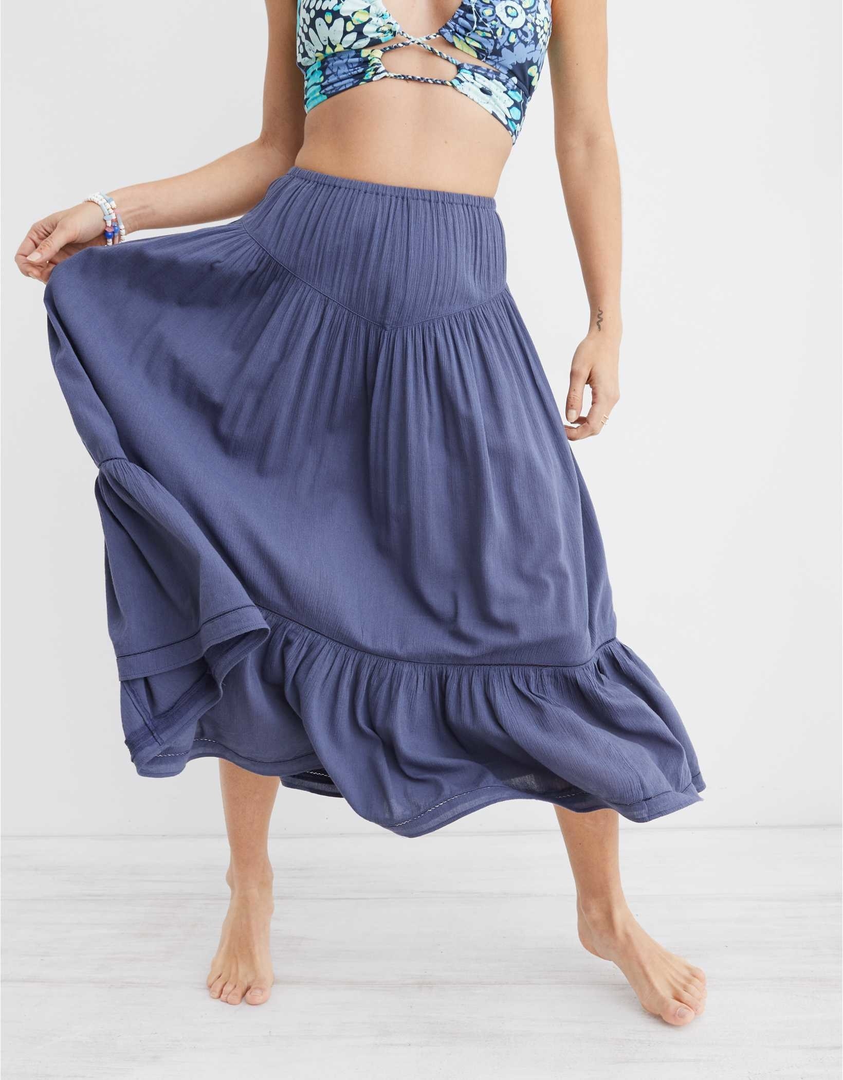 model in a dark blue slightly pleated flowy midi skirt