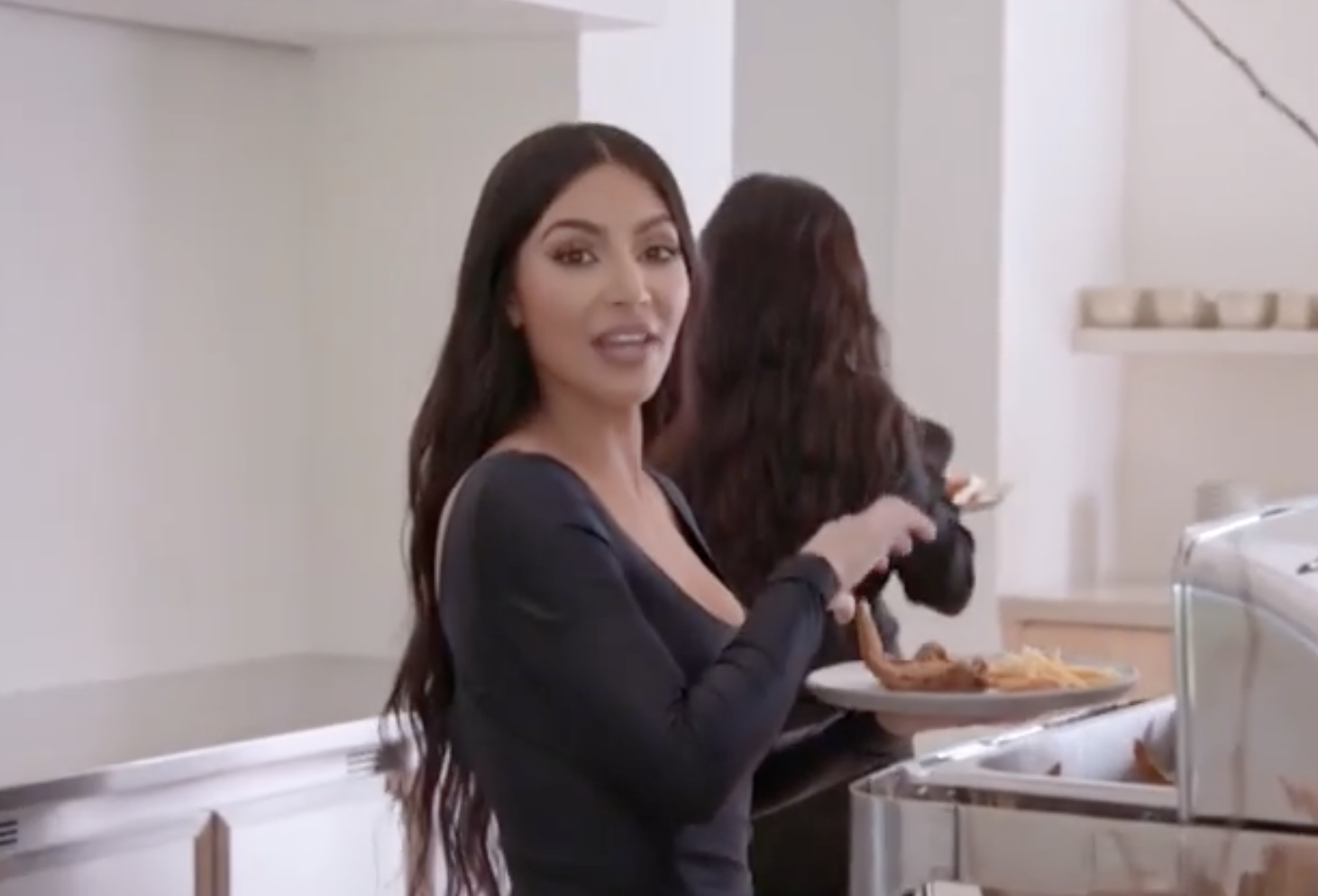 Kim speaks to the camera in this still from the promotional video