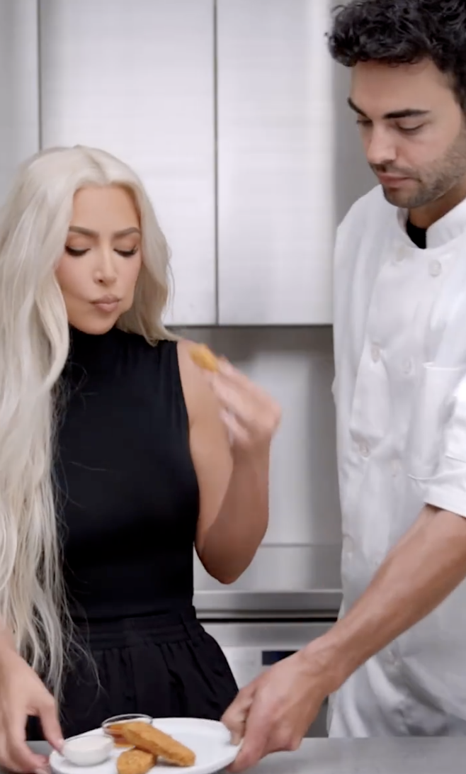 Kim and a chef tug back and forth on a plate of Beyond chicken nuggets in the promotional video