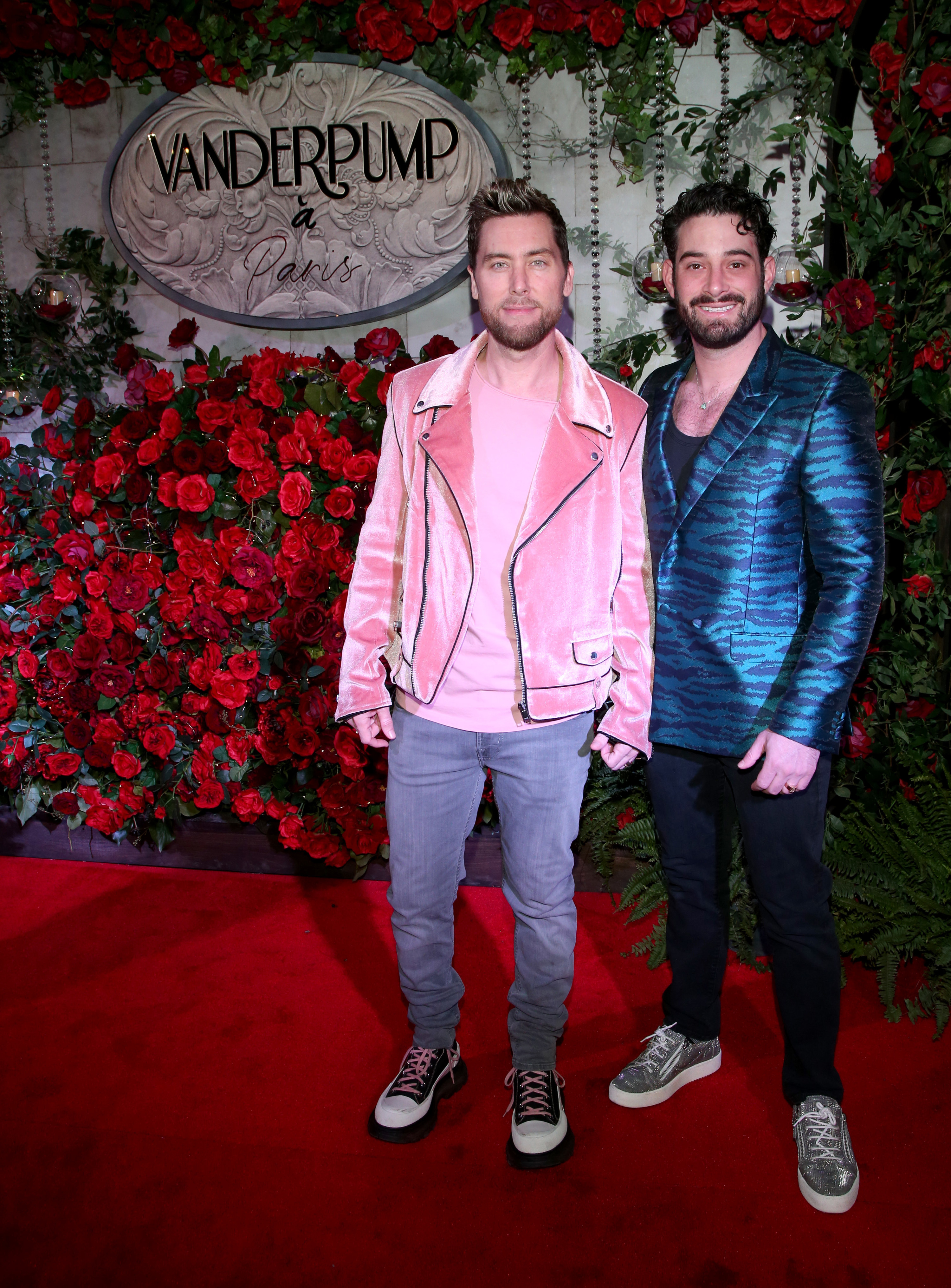 Lance Bass and Michael Turchin hold hands on the red carpet