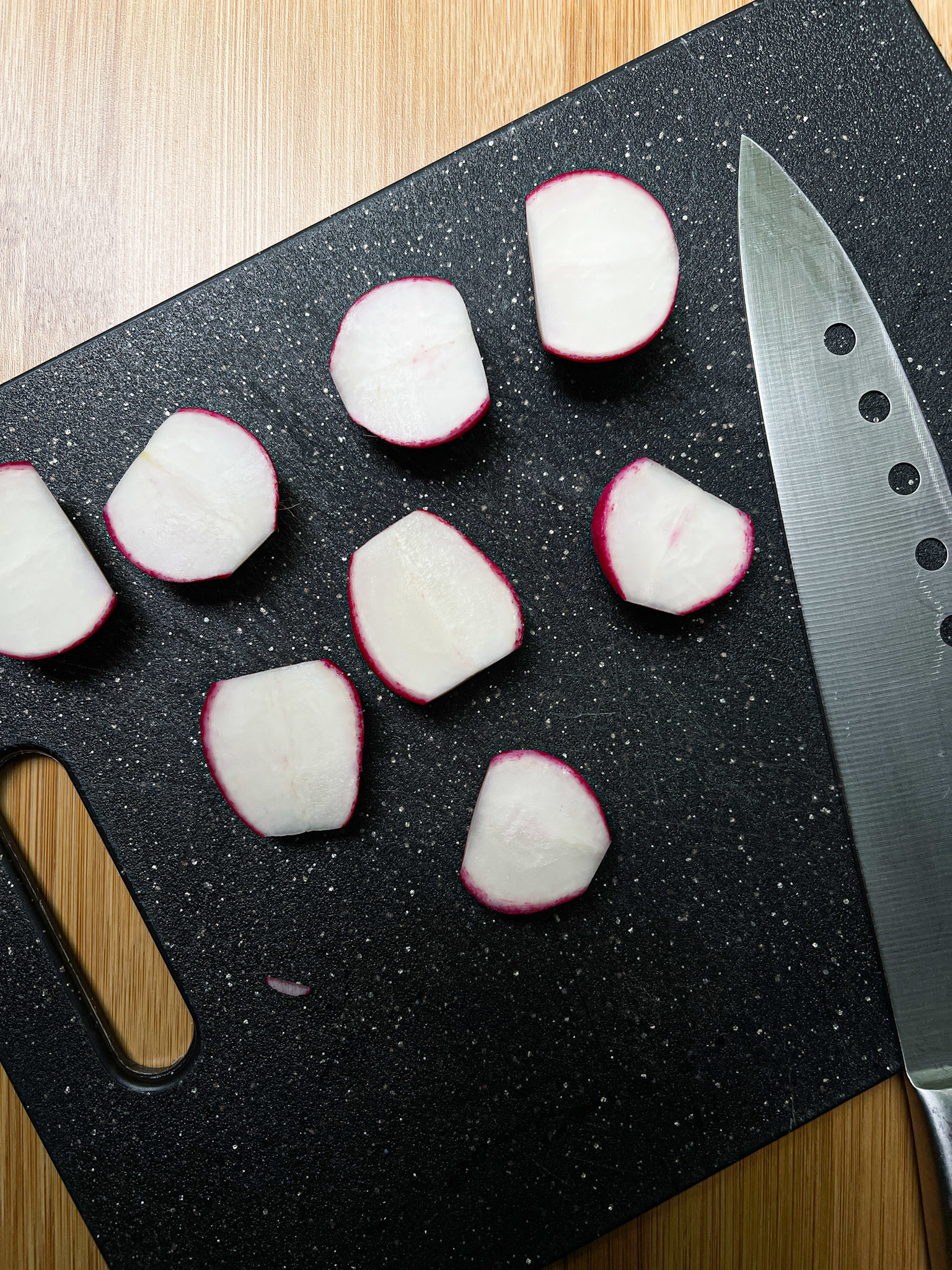 Halved radishes on a cutting board