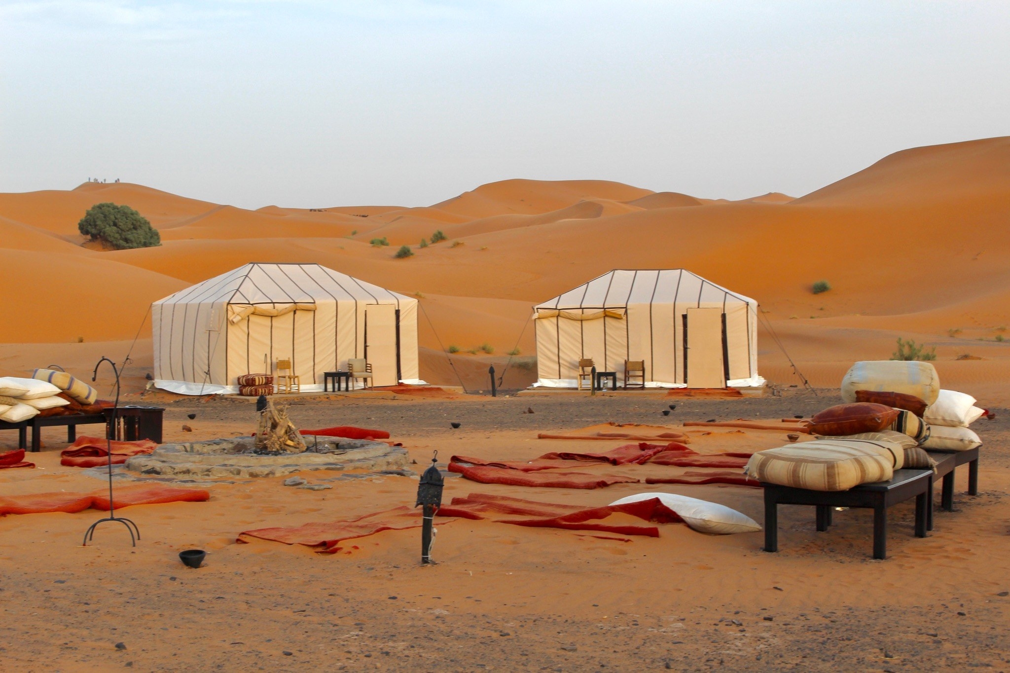 A campsite and tents surrounded by dunes in the Sahara Desert