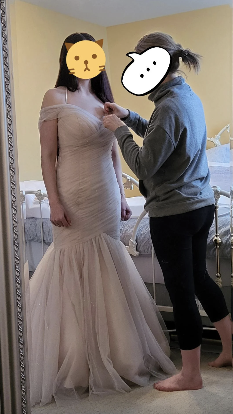 A woman wearing a dress getting it altered