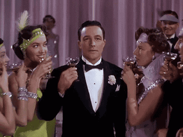 a gif of Gene Kelly from Singin In the Rain looking longingly off camera