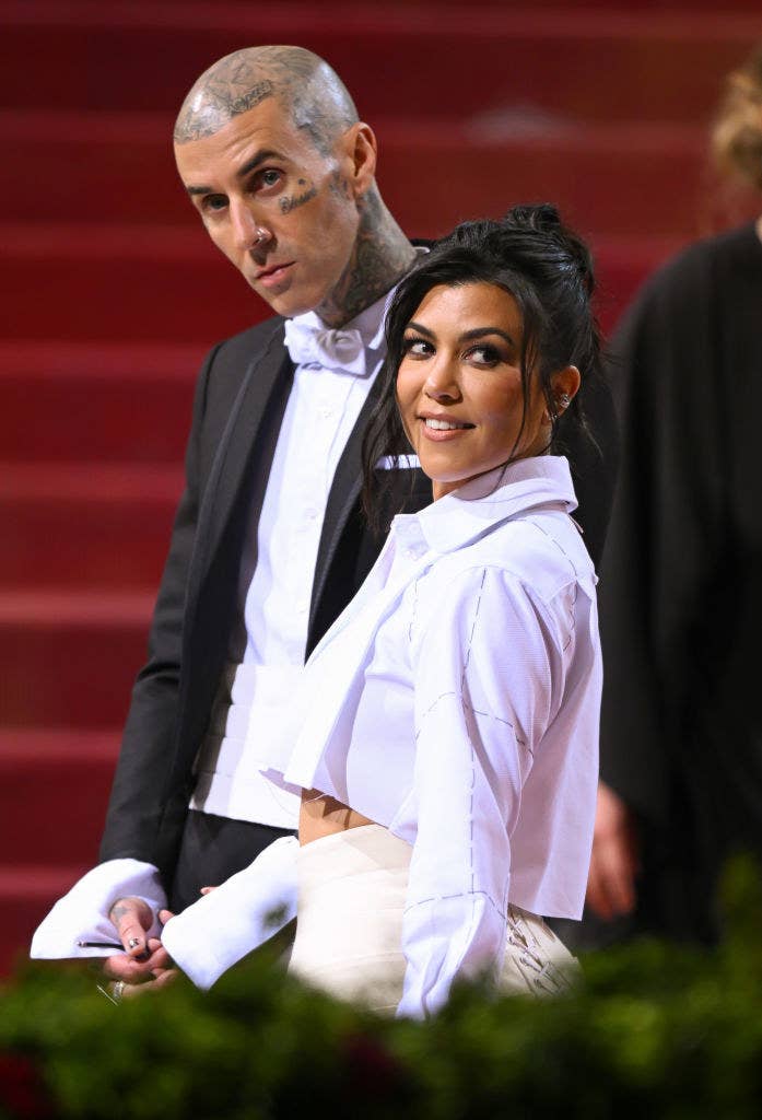 Travis and Kourtney posting on the Met Gala stairs