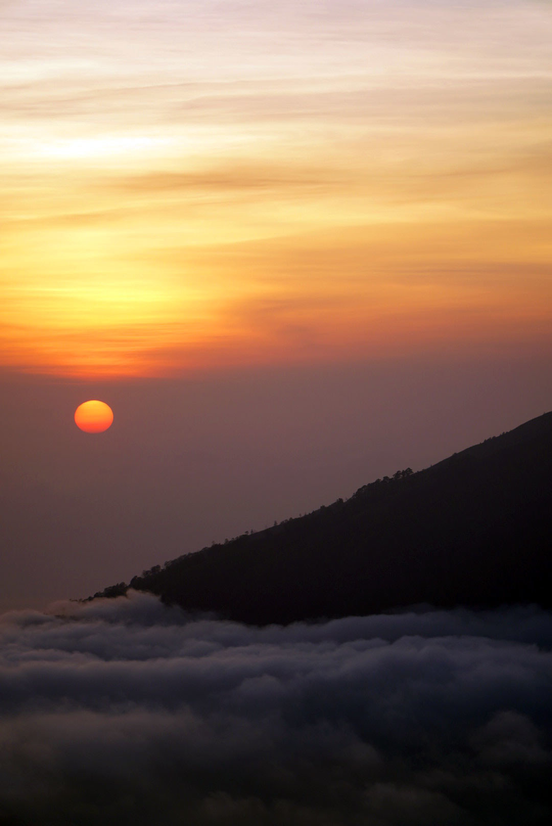 A sunrise over a volcano