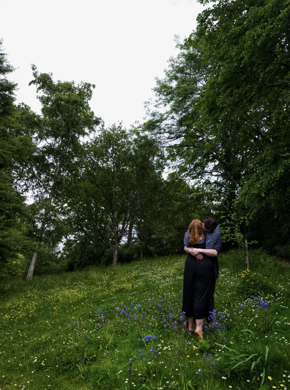 A couple hugging while taking engagement photos