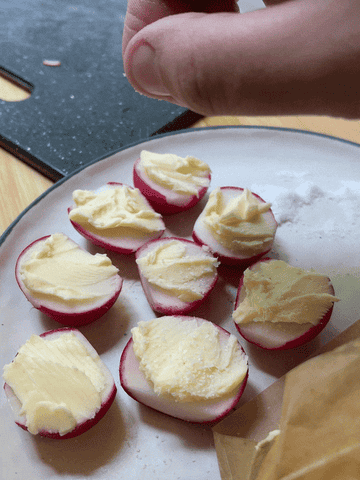The writer sprinkle salt on top of the buttered radishes