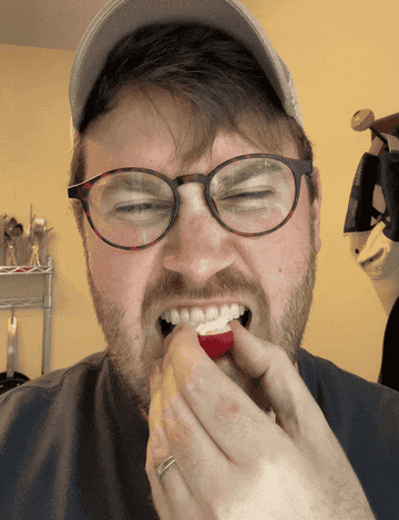 GIF of the author biting into the radish and opening their eyes wide with delight