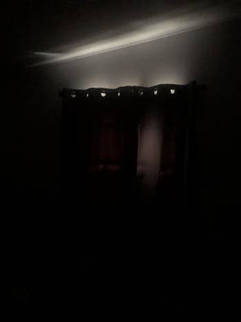 the grey curtains blocking out almost all the light