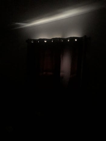 the grey curtains blocking out almost all the light