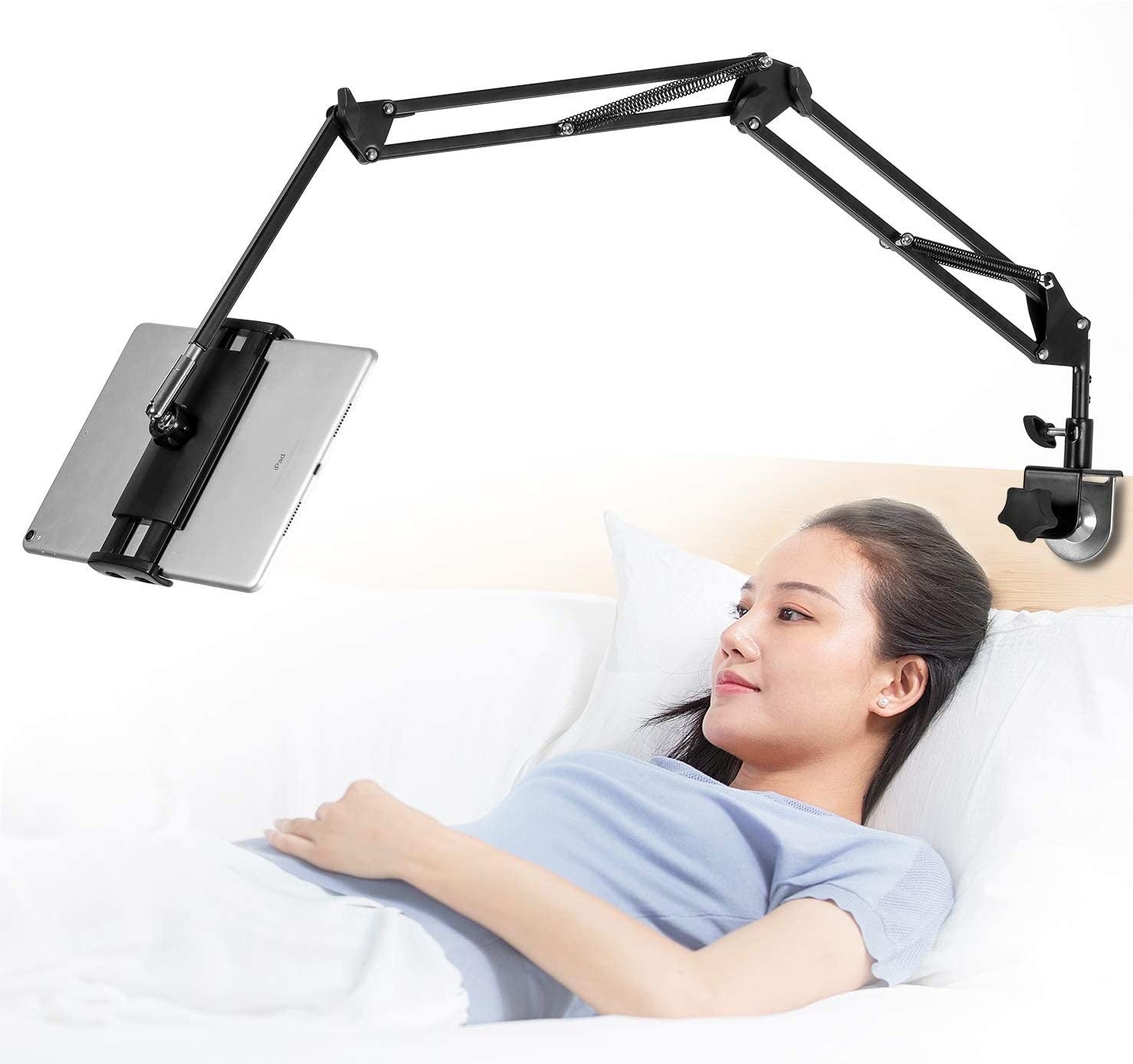 someone laying in bed with their tablet suspended overhead