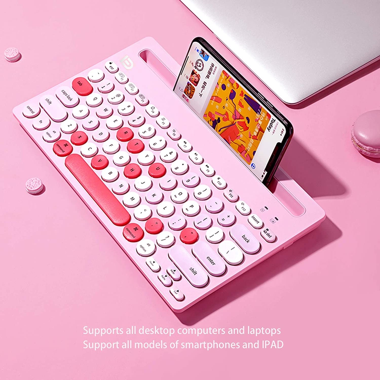 a colourful bluetooth keyboard with a phone perched in the special holder