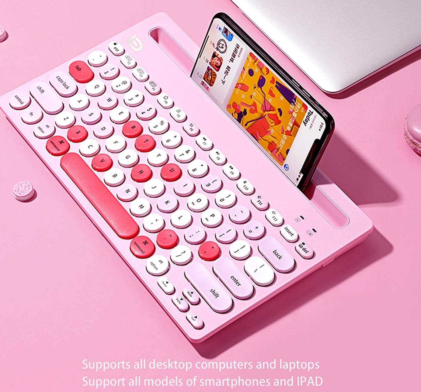 a colourful bluetooth keyboard with a phone perched in the special holder