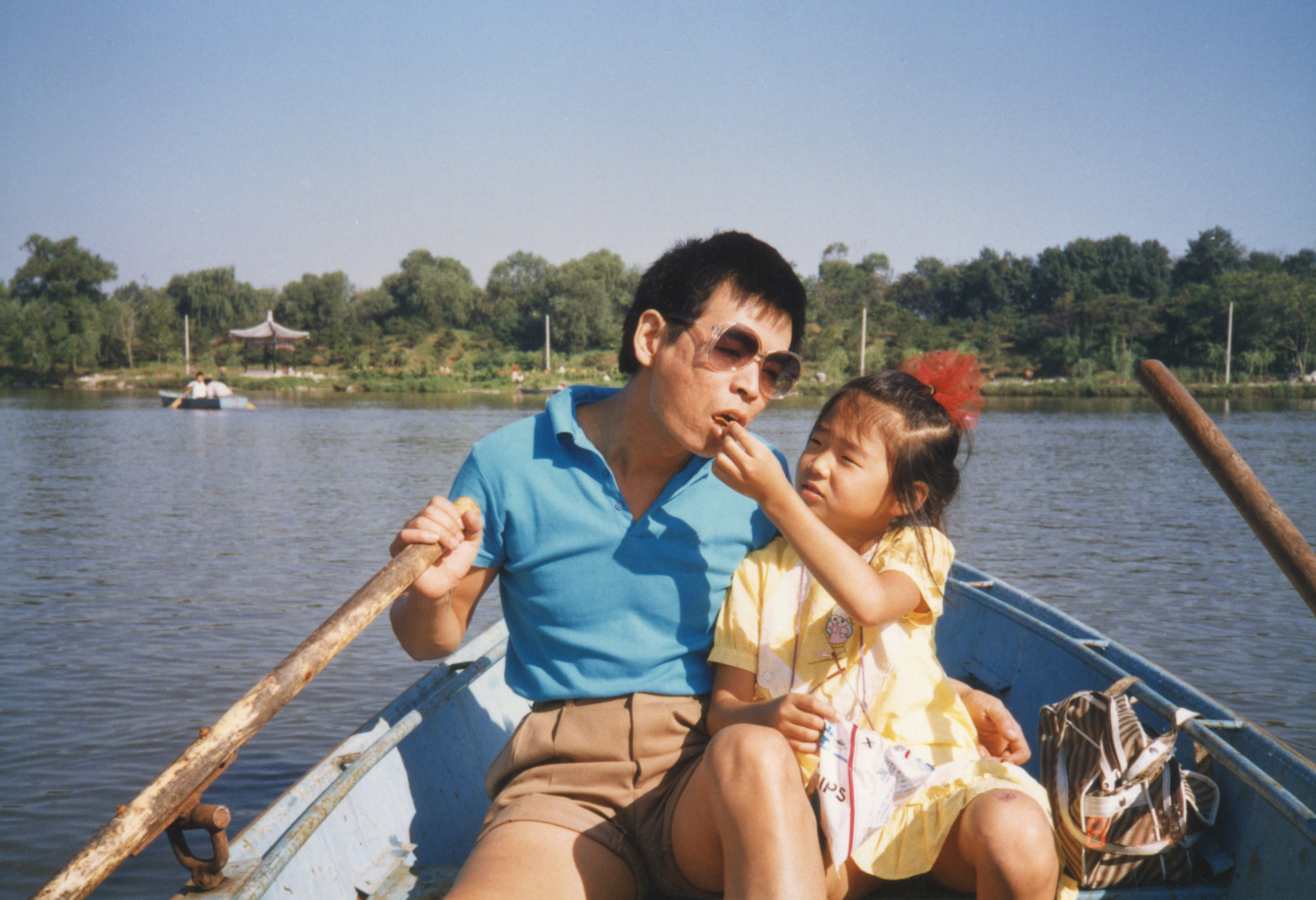 a dad and his daughter on a canoe
