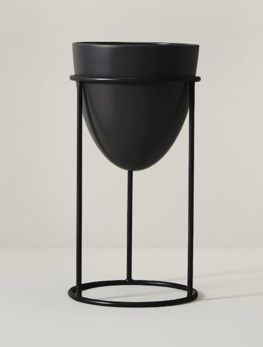 the planter on the stand against a plain background