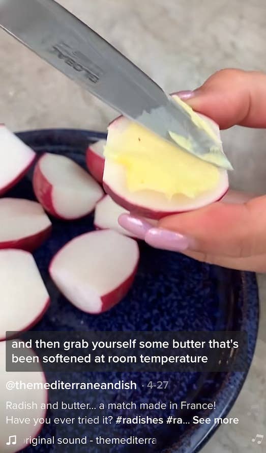 Screenshot of a TikTok video with someone buttering a halved radish