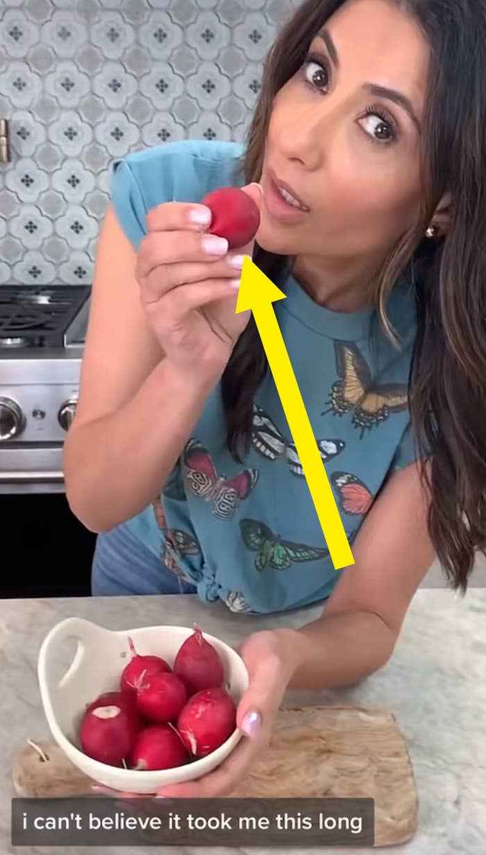 woman holding a bowl full of radishes