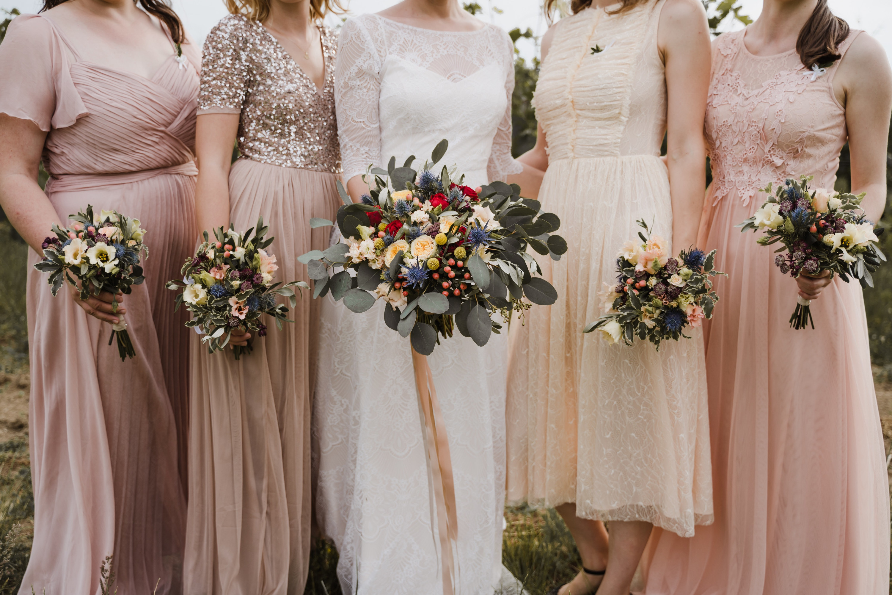 A bridal party posing for pictures with the bride