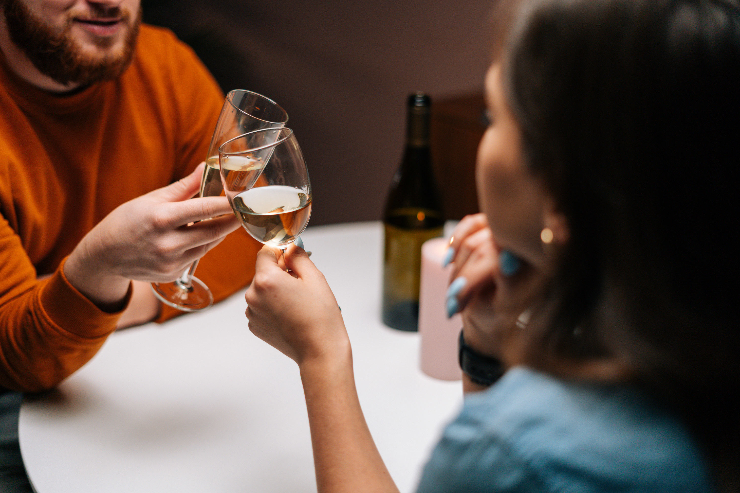 a couple clinking their wine glasses together