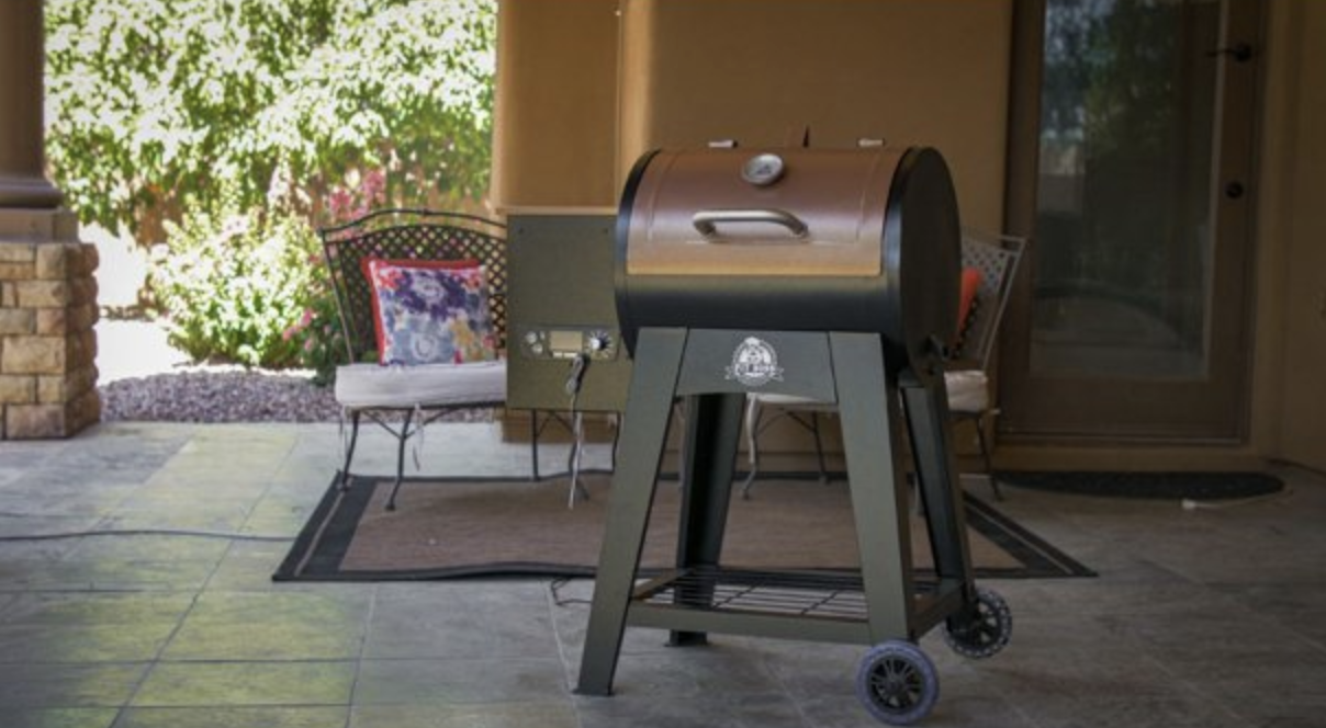the large pellet grill next to a patio seating set