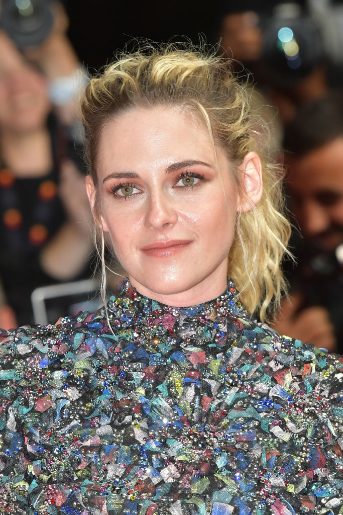 Kristen slightly smiling in a dress and hair pulled in a pony