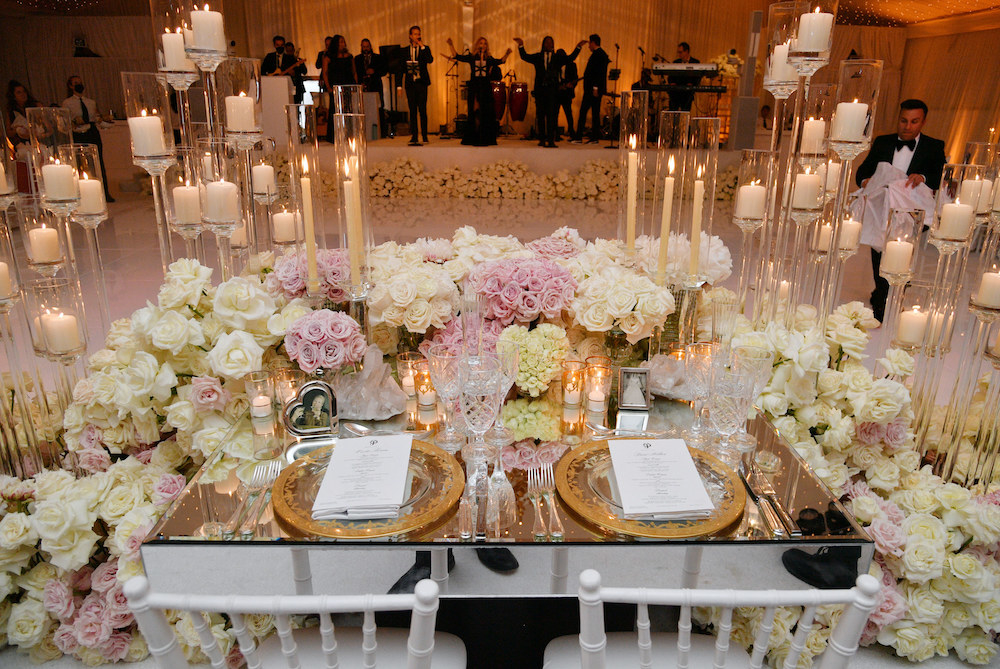 A table setting festooned with flowers and candles