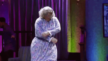 Old woman dancing with a dress on