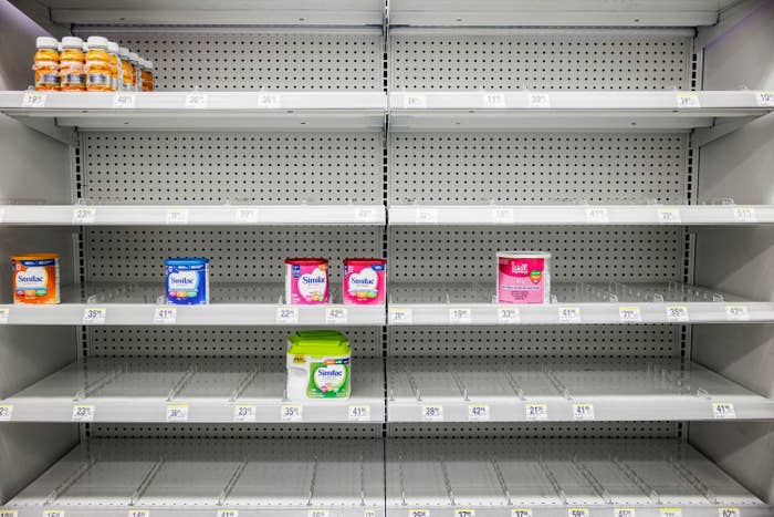 Store shelves with just a few containers of formula on them