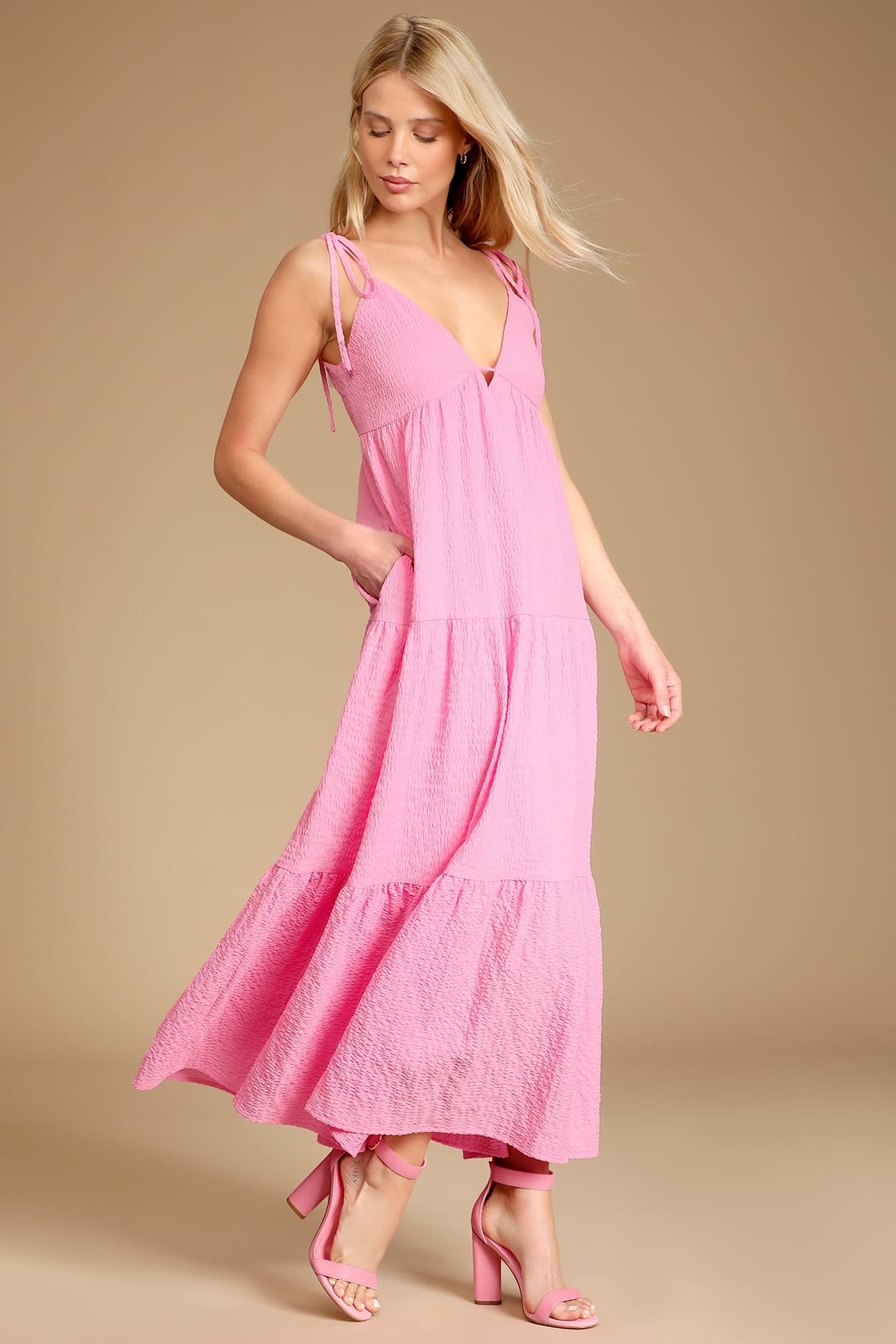 a model wearing the dress in pink
