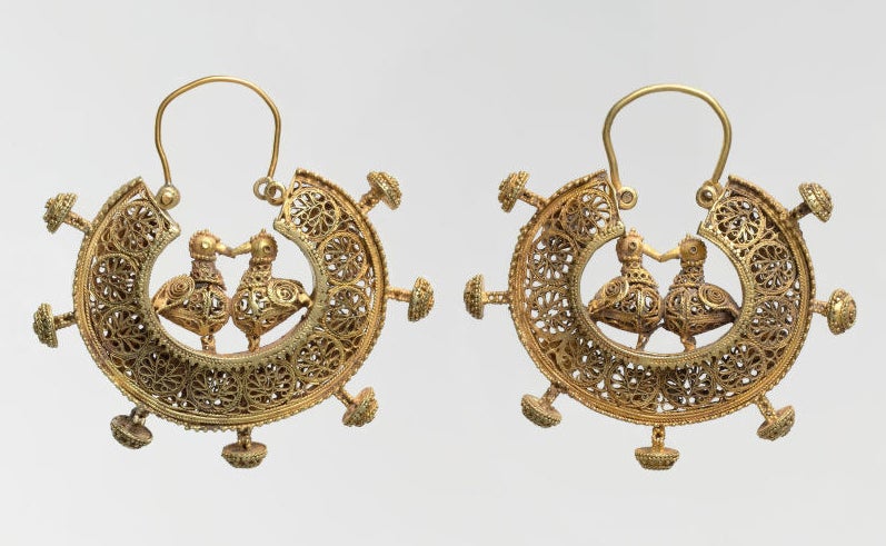 gold earrings with ducks kissing in the middle of a semi-circular design