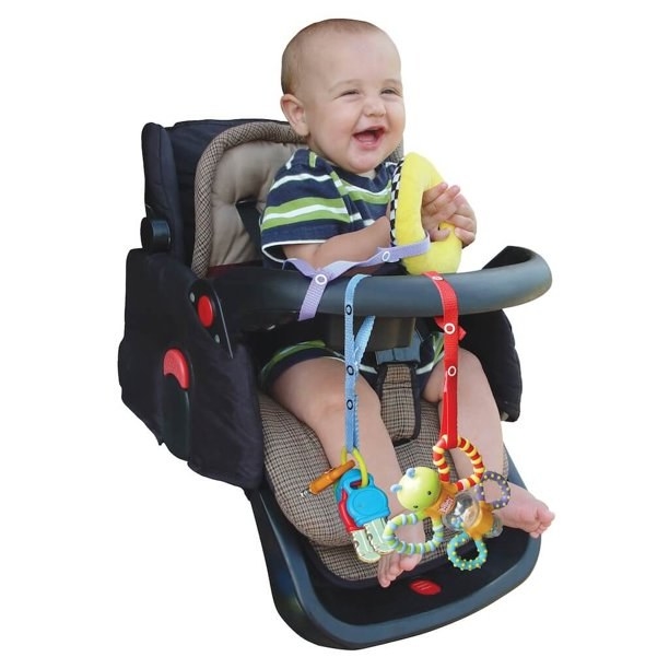 Baby in car seat with toys secured on it