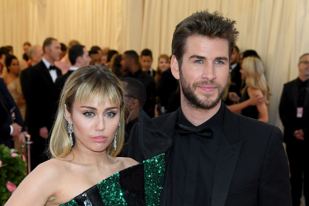 Miley and Liam standing together at a black-tie event