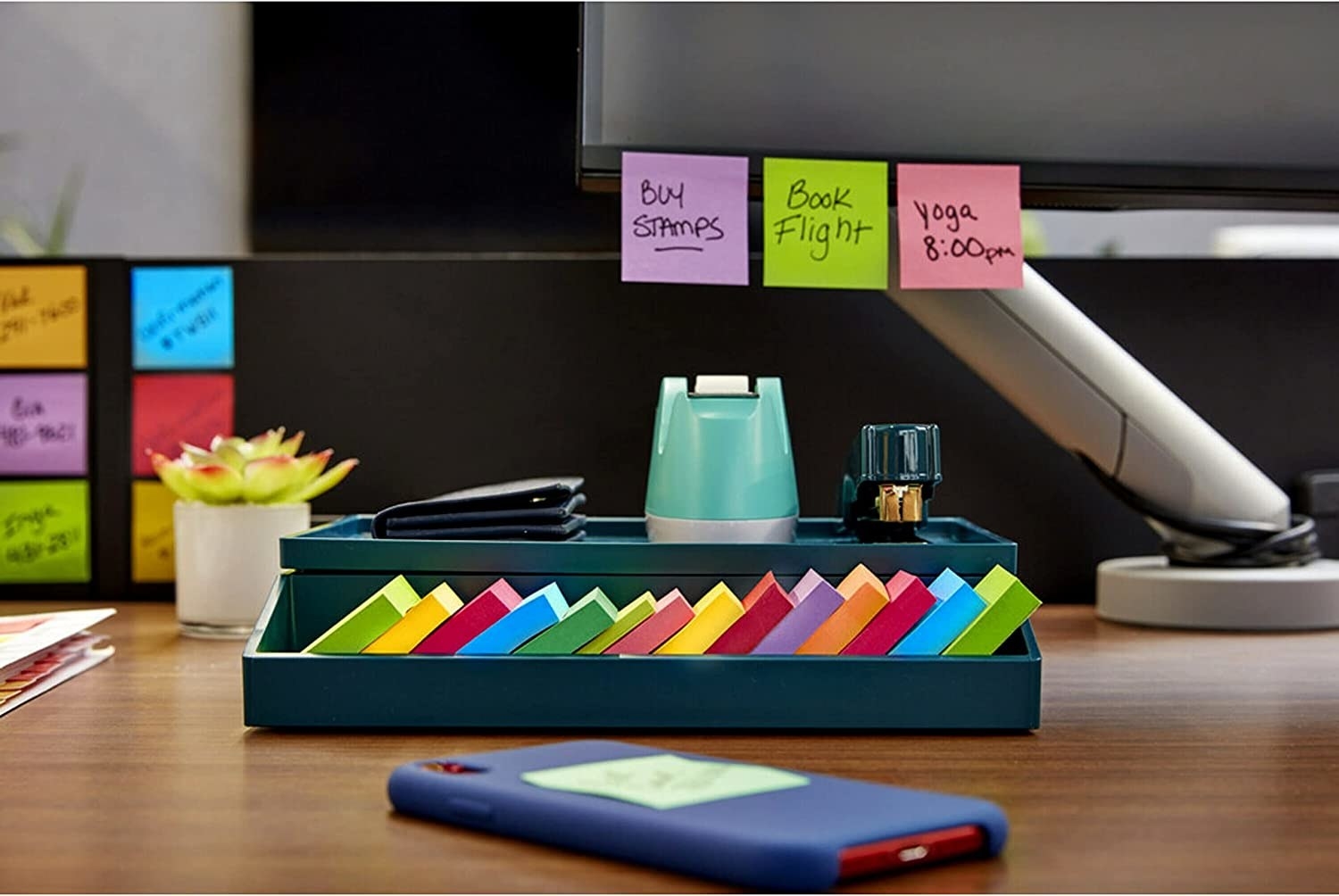 the post-it notes on a desk and on a computer