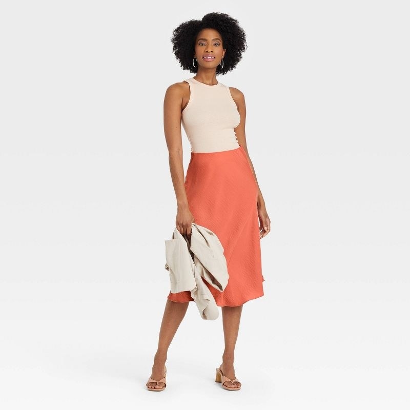 model wearing the coral colored skirt