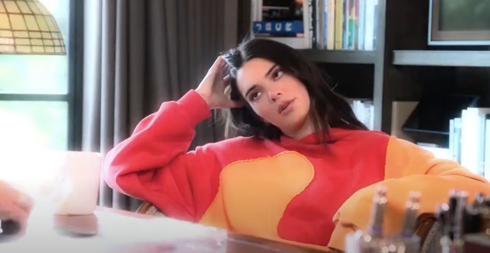 Kendall looking thoughtful and touching her hair