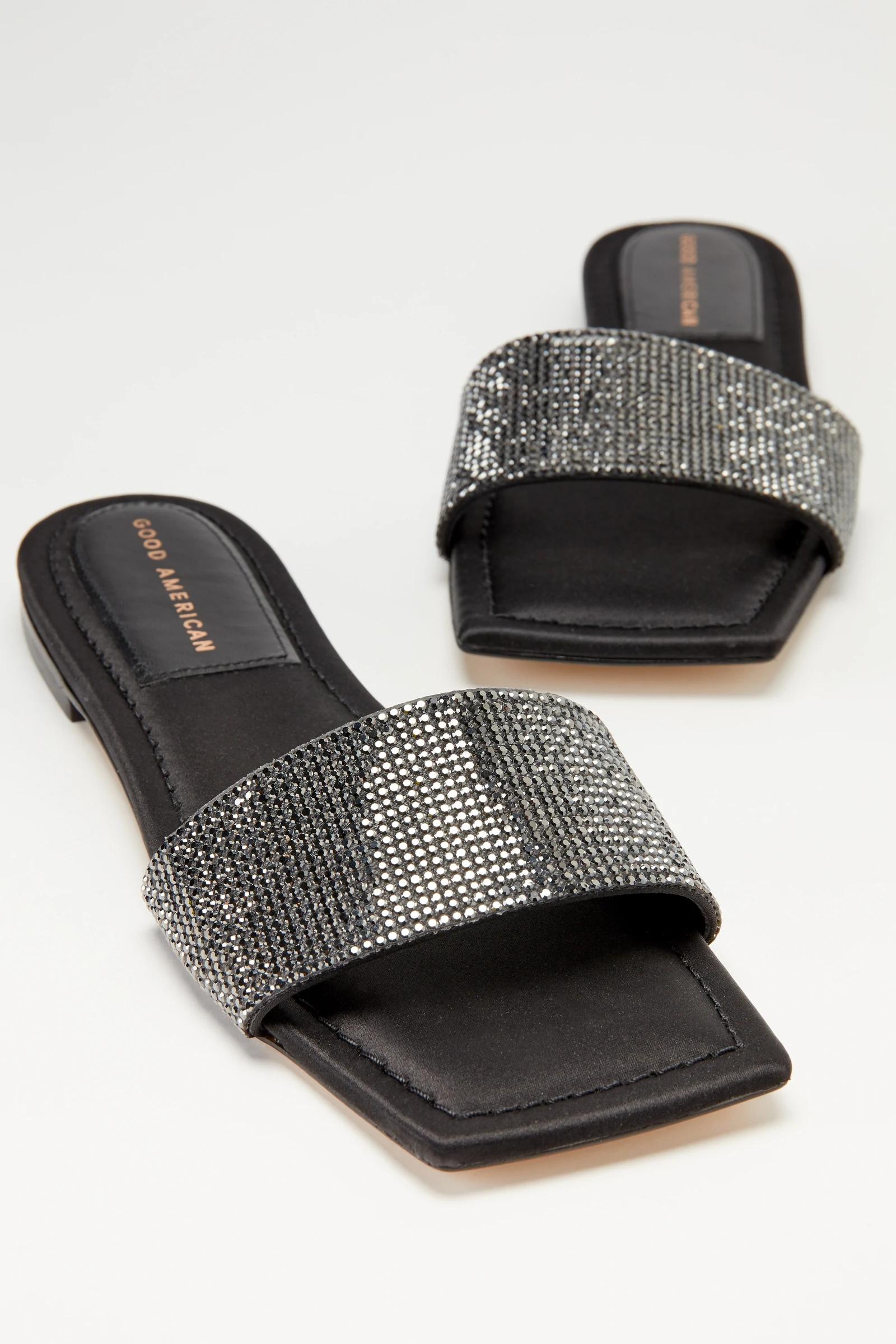 A pair of square toe sandals with crystals on the strap